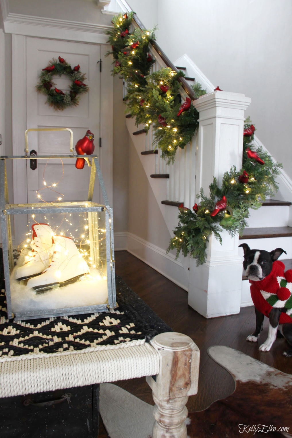 Gorgeous Christmas garland on the bannister covered in red cardinal ornaments kellyelko.com