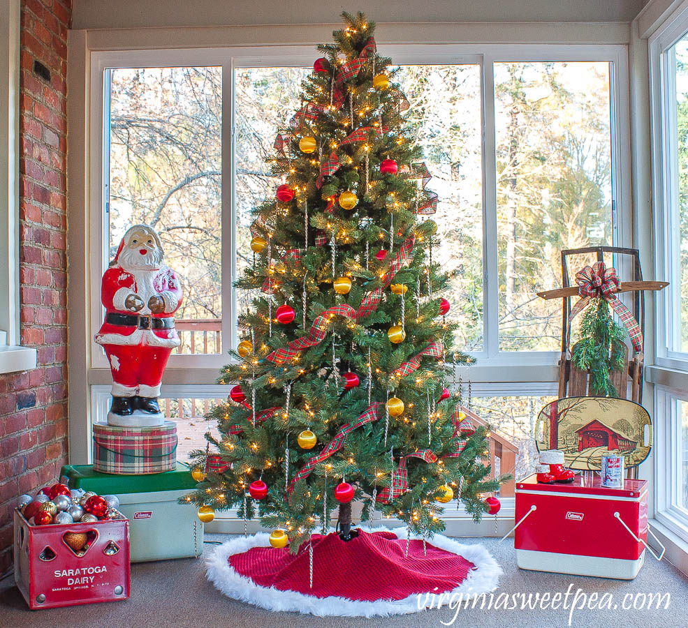 Love this fun and colorful vintage porch and the Santa blow mold, old coolers and sled #vintagechristmas #christmasdecor #kitschchristmas #blowmold #christmasporch #vintagedecor 