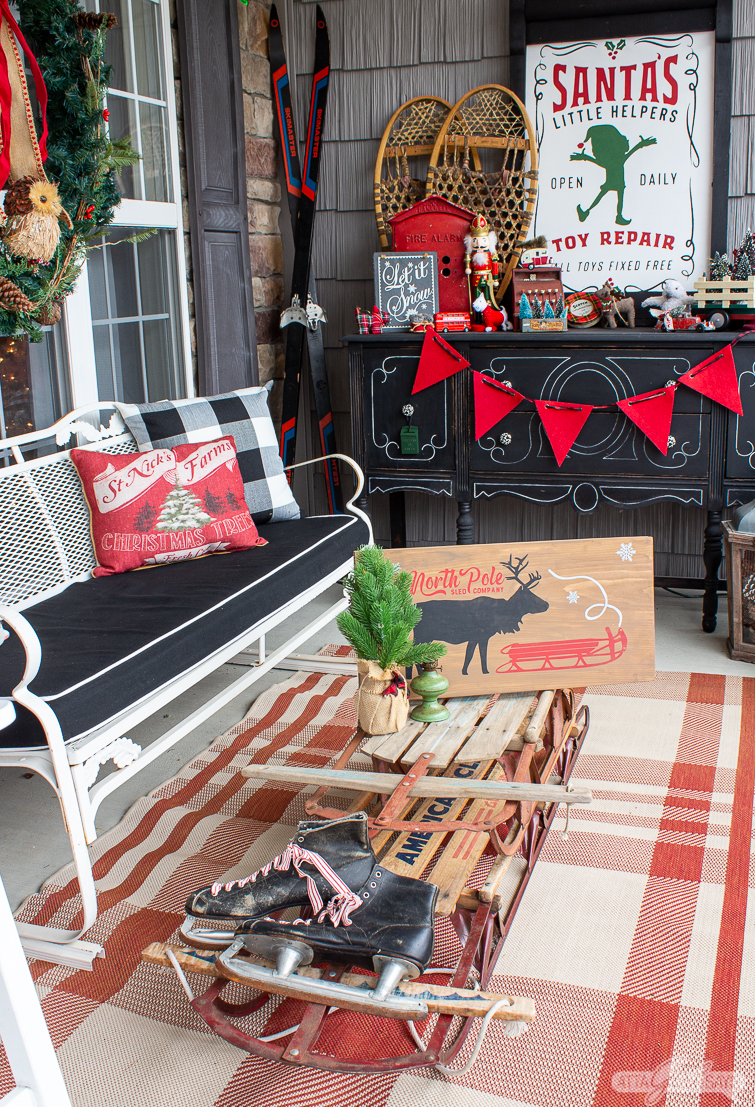 Fun and colorful Christmas porch filled with tons of creative ideas like the vintage sled coffee table #christmas #christmasporch #vintagechristmas #christmasdecor #colorfulchristmas #kidschristmasdecor 