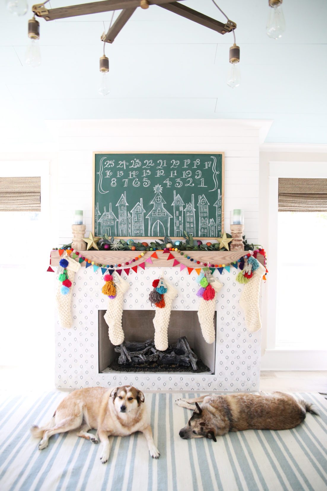 Love this colorful Christmas mantel and chalkboard Advent calendar #colorfulchristmas #christmasdecor #christmasmantel #adventcalendar #chalkart #christmaschalkart 