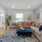 Slow decorating home makeover - love this cozy family room with sectional sofa and blue and white rug kellyelko.com #livingroom #livingroommakeover #livingroomdecor #roommakeover #beforeandafter #cozyhome #kellyelko