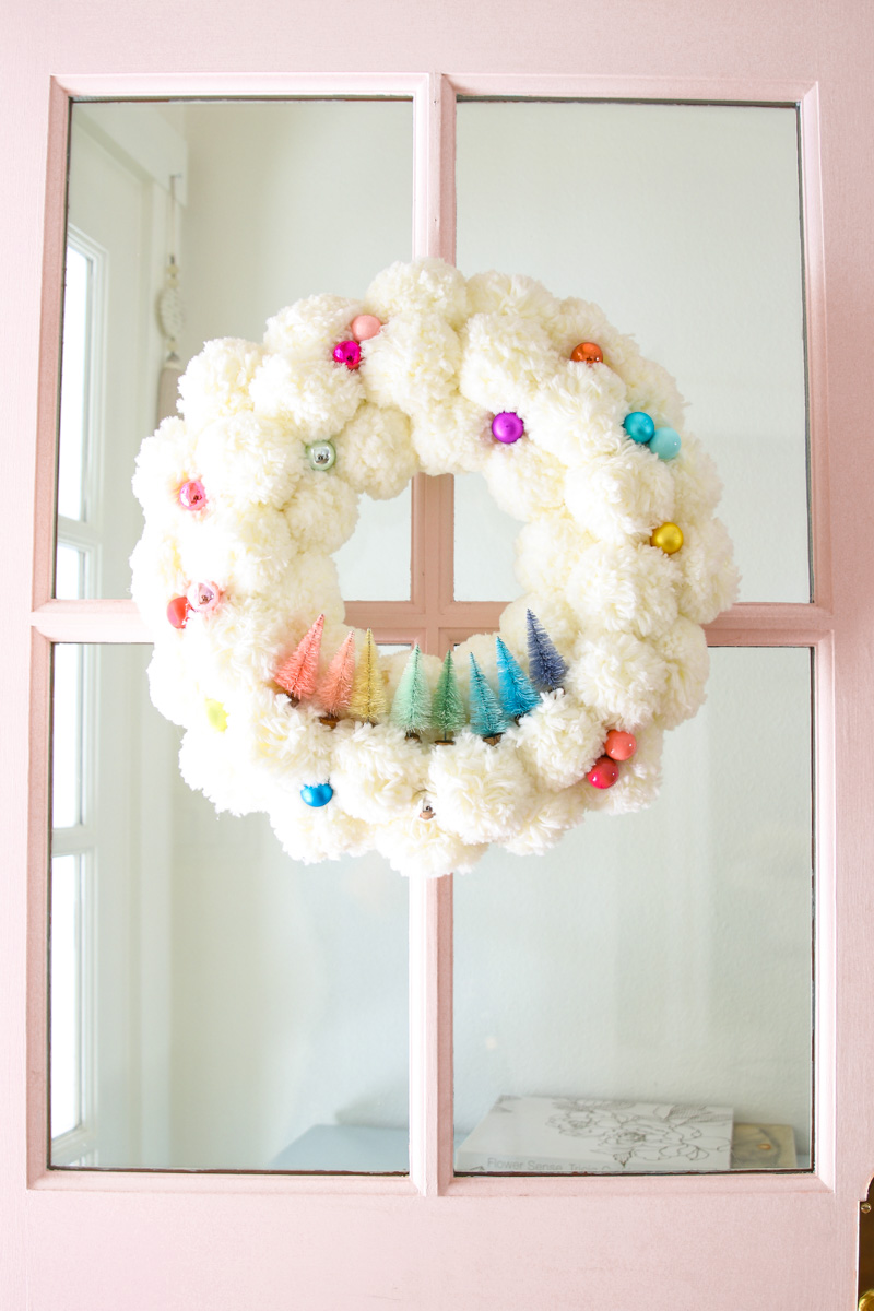 How to make a pom pom wreath with bottle brush trees #christmasdecor #christmascrafts #christmaswreath #diychristmas #colorfulchristmas #christmasdecorations 