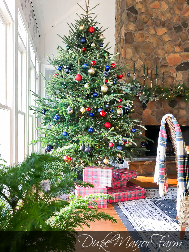 Festive Christmas Decorating Ideas - love this huge tree decked out in red, whites and blue #christmastree #christmasornaments #christmasdecor #realchristmastree #plaid 