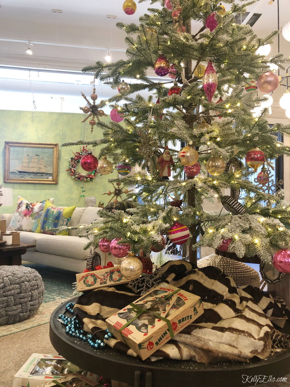 A tree full of vintage Shiny Brites with a cow hide used as a tree skirt! kellyelko.com #cowhide #christmastree #vintagechristmas #shinybrites #treeskirt #vintageornaments #kellyelko