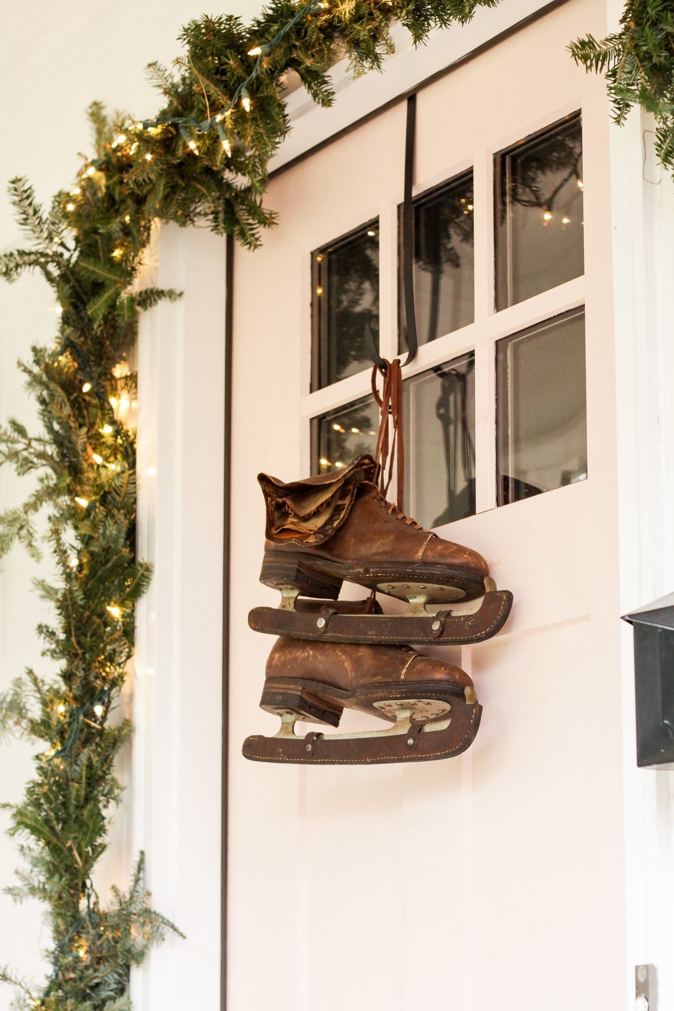 Festive Christmas Decorating Ideas - love these antique ice skates instead of a wreath #vintagechristmas #iceskates #christmaswreath #christmasdecor 