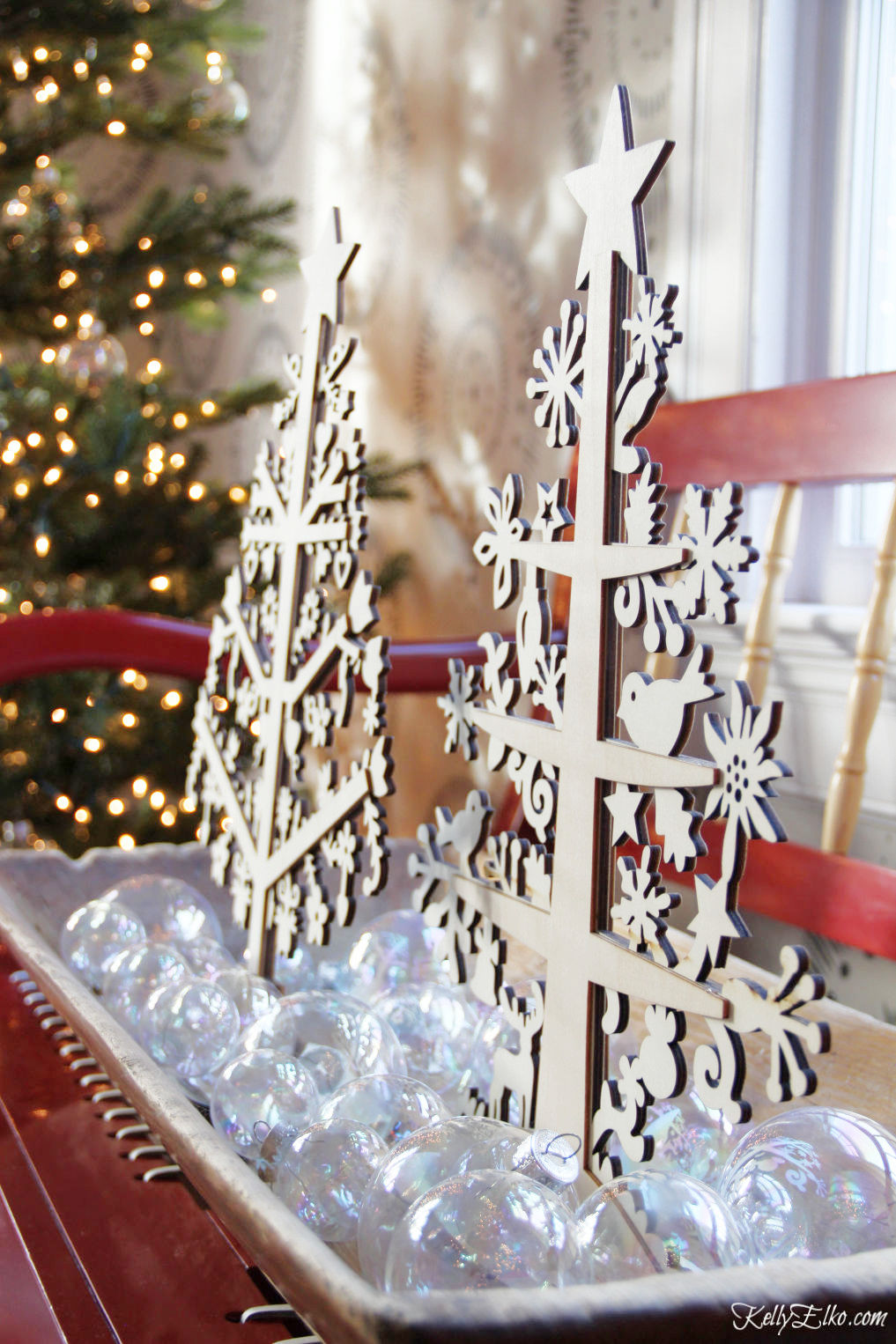 Creative Christmas Home Tour - love this dough bowl filled with clear ornaments and wood cut trees kellyelko.com #christmas #christmasdecor #christmasdecorating #christmashome #christmastour #diychristmas #christmasideas #christmasmantel #christmastree #christmasornaments #vintagechristmas #farmhousechristmas #colorfulchristmas #creativechristmas #kellyelko #doughbowl 