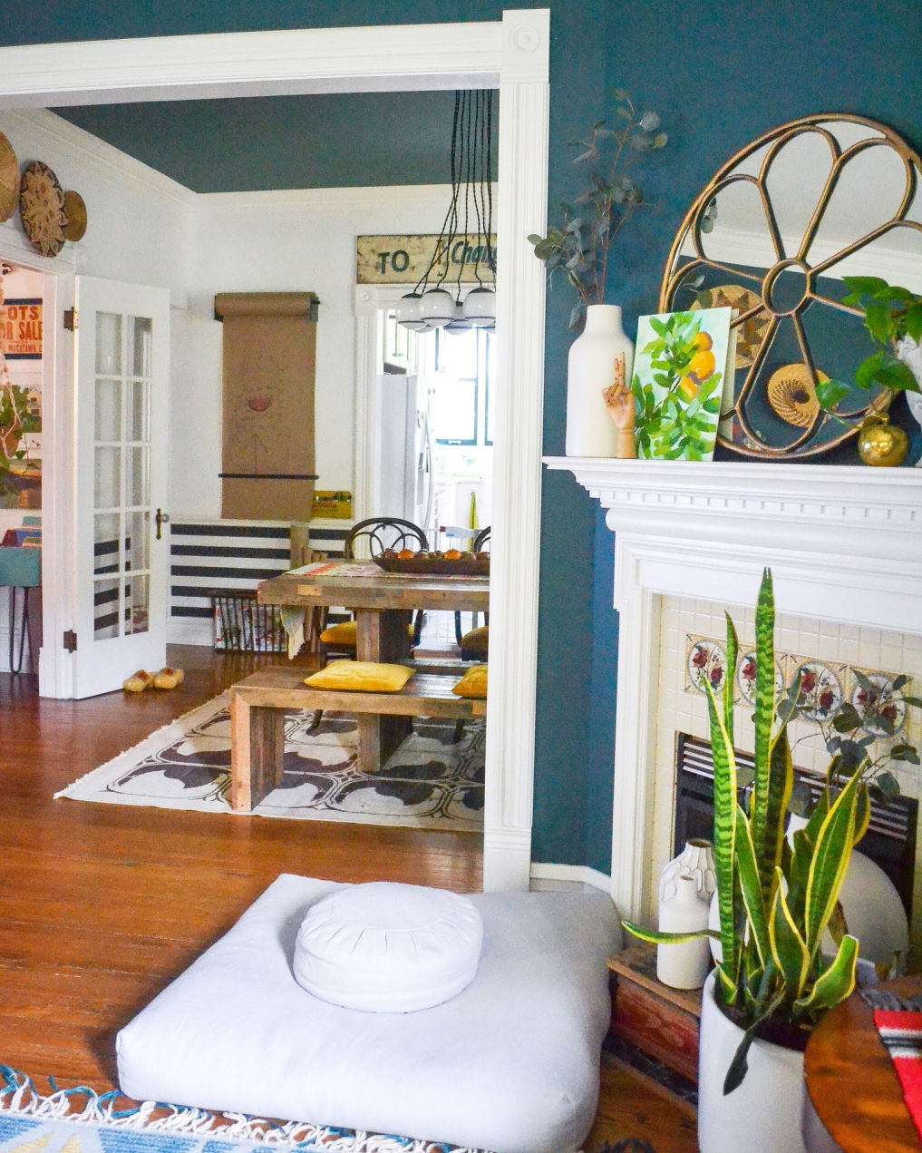 Love this old home with blue walls and eclectic decor #bluepaint #manteldecor #mantel #eclecticdecor #vintagedecor #bohodecor #hometour #diningroomdecor / kellyelko.com