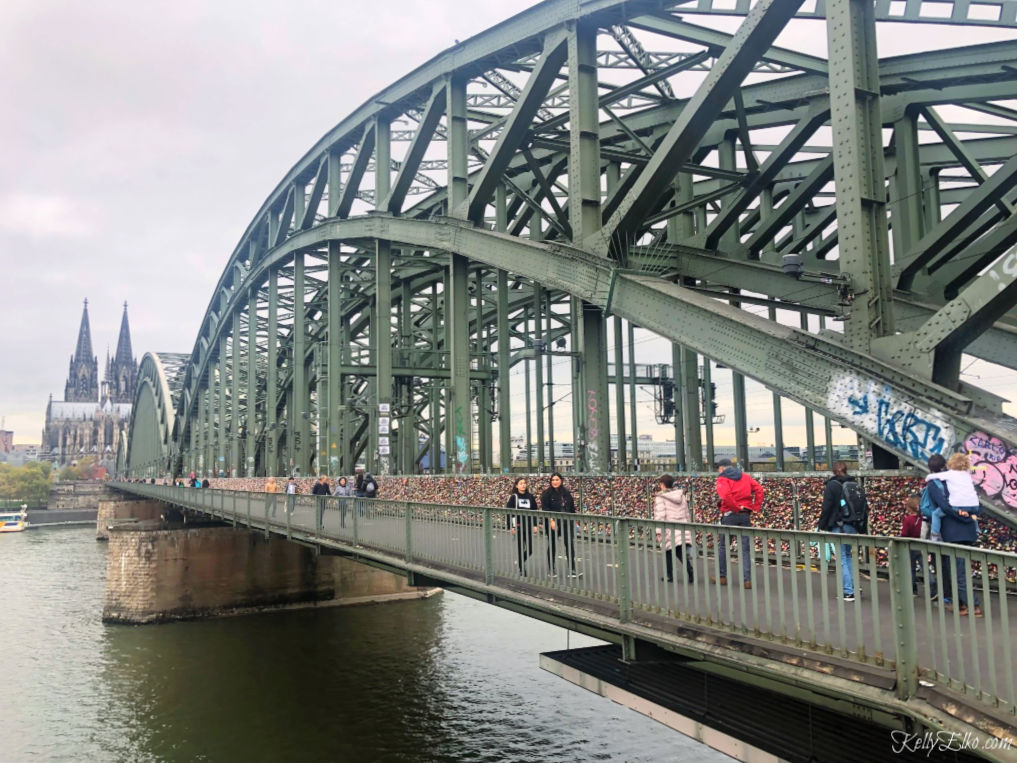 Love Locks Bridge overlooks the Cologne Cathedral in Cologne Germany kellyelko.com #lovelocksbridge #colognegermany #colognecathederal #rhineriver #rivercruise #travel #travelblogger 