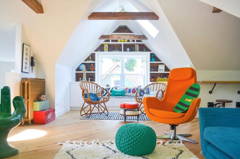 Attic playroom with colorful vintage furniture and wood ceiling beams #bohodecor #kidsrooms #playrooms #atticdecor #midcenturydecor #vintagedecor #colorfuldecor / kellyelko.com