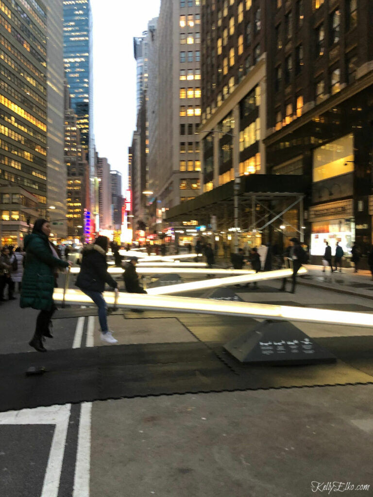 Giant glow in the dark teeter totters in New York kellyelko.com #nyc #newyork #manhattan #travel #travelblogger #travelblog #vacation #kellyelko