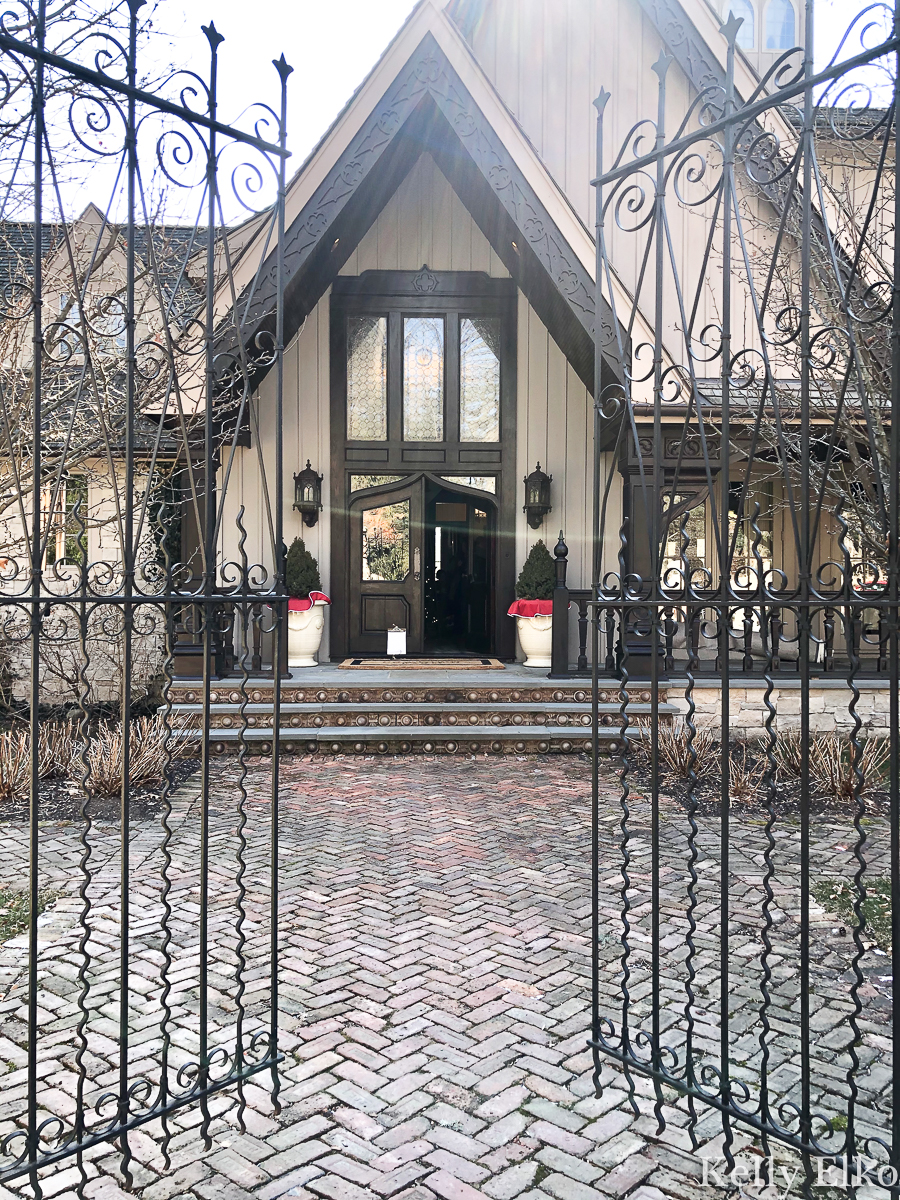 Beautiful iron gates lead and brick herringbone path lead to this stunning home kellyelko.com #gates #irongates #ironwork #oldhome #brickpath #brickwalkway #frontporch 