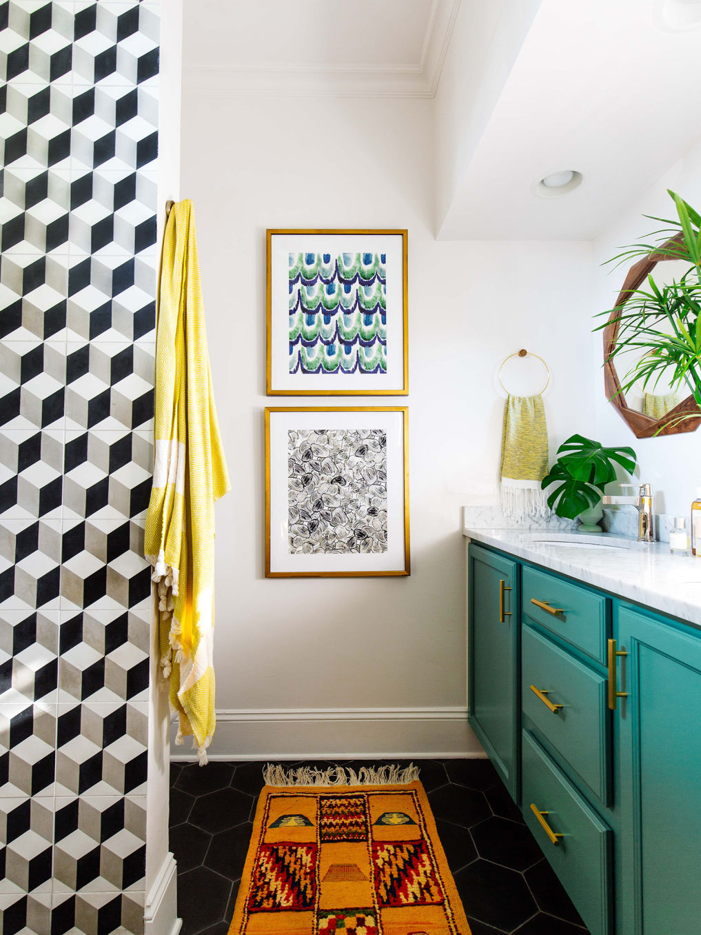 Graphic black and white tile in this small bathroom with turquoise vanity #bathroom #tile #blackandwhite #bathroomvanity #bathroomdecor