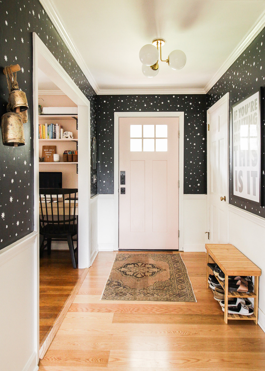 Love this foyer with graphic black and white wallpaper and blush pink front door 