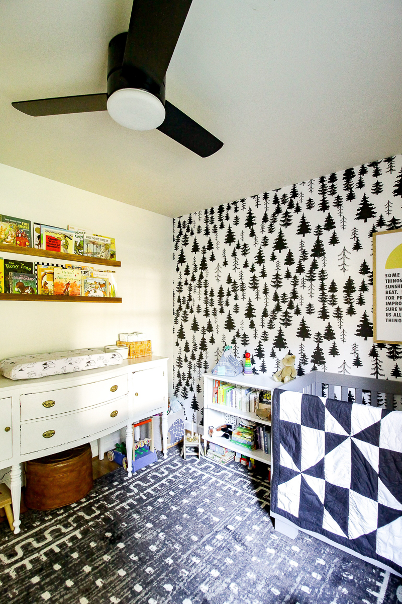 Love this adorable nursery with black and white tree wallpaper 