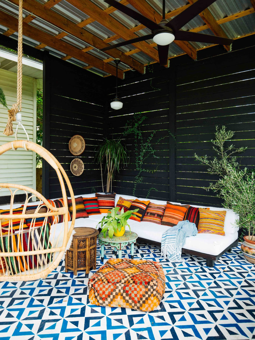 Love this colorful patio with stenciled concrete and colorful pillows #patio #patiodecor #patiofurniture #bohodecor #eclecticdecor 