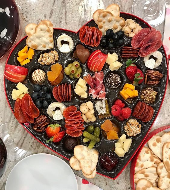 Make this epic Valentine heart shaped charcuterie board for Valentine's Day kellyelko.com #charcuterie #charcuterieboard #snackboards #valentinesparty #valentineparty #valentinefood #valentinerecipes #partyfood #valentineideas 