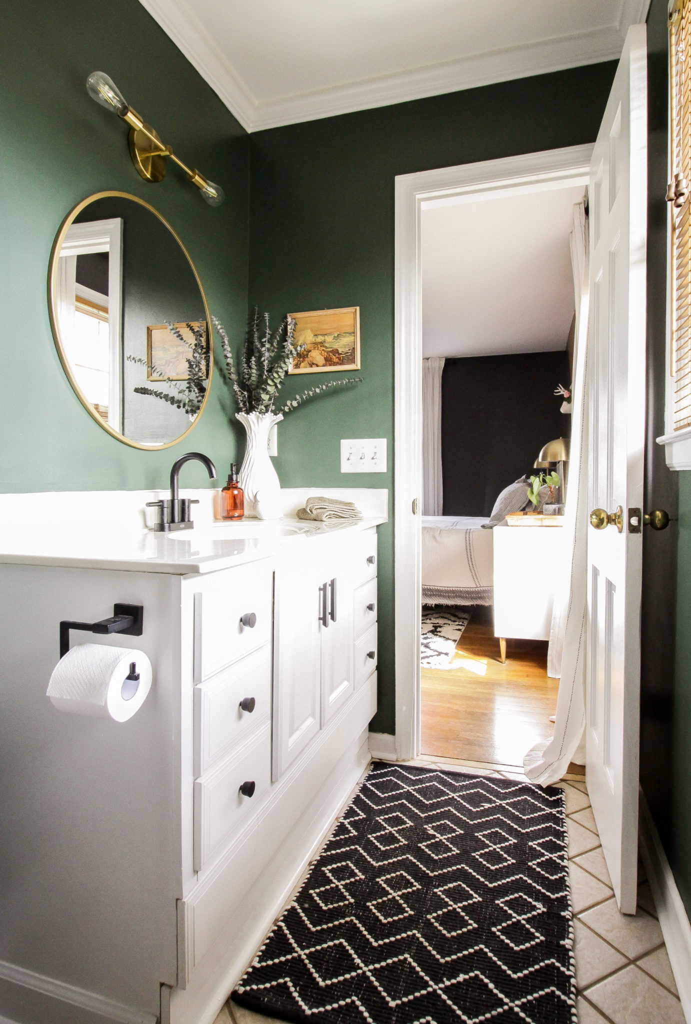 Hunter green bathroom with brass fixtures 