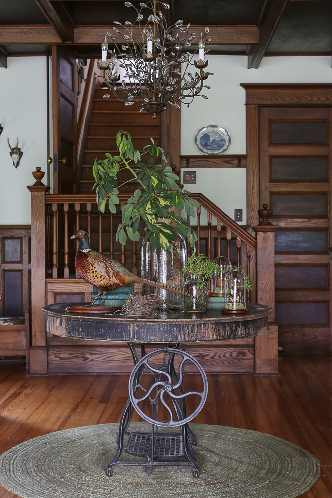 Tour this charming farmhouse filled with original walnut wood trim and an eclectic mix of furniture and accessories including a taxidermy pheasant and crystal chandelier kellyelko.com #rusticdecor #farmhouse #farmhousedecor #oldhome #antiquehouse #farmhouse #farmhousedecor #countryliving #vintagemodern #pheasant #taxidermy #fixerupper #fixerupperstyle #antiques 