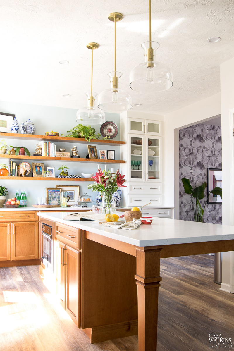 Eclectic Home Tour - love this kitchen with open shelves filled with vintage finds and the brass lights and hardware #kitchen #kitchendecor #openshelves #bohodecor #kitchenisland #lighting #brass #thrifted 