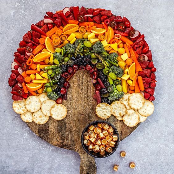 How fun is this rainbow charcuterie snack board filled with colorful fruits and vegetables - perfect for St Patrick's Day #stpatricksday #partyfood #rainbow #appetizers #snacks #snackboard #charcuterie #charcuterieboard 