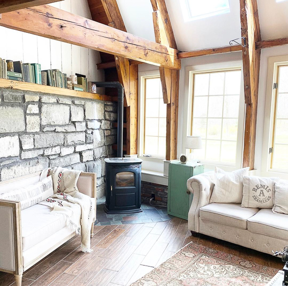 Love the wood beams in this farmhouse family room #woodbeams #familyroom #familyroomdecor #farmhouse #farmhousedecor #neutraldecor #cozydecor #stone #stonewall 