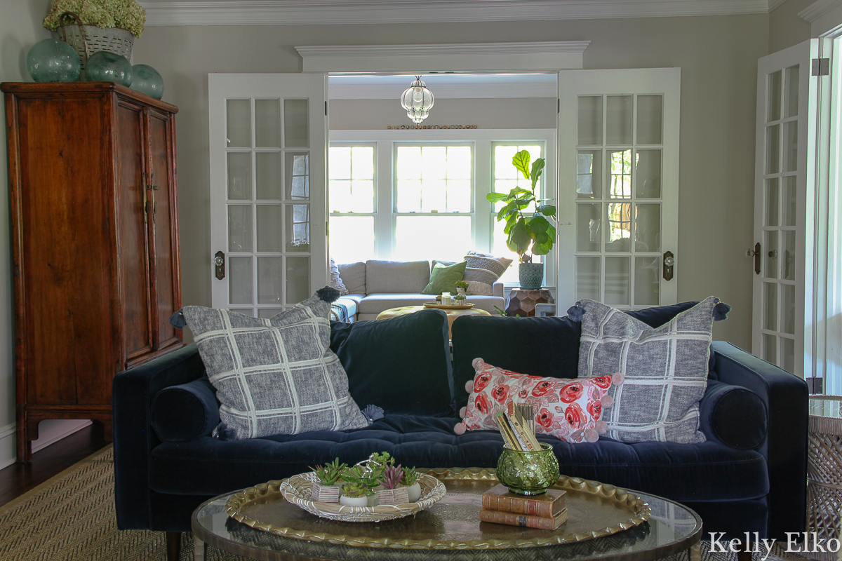 Love this eclectic living room with blue velvet sofa and lots of vintage finds kellyelko.com #vintage #vintagedecor #eclecticdecor #bohodecor #articlesofa #svensofa #modernvintage #interiorstyling #livingroom #livingroomdecor #kellyelko