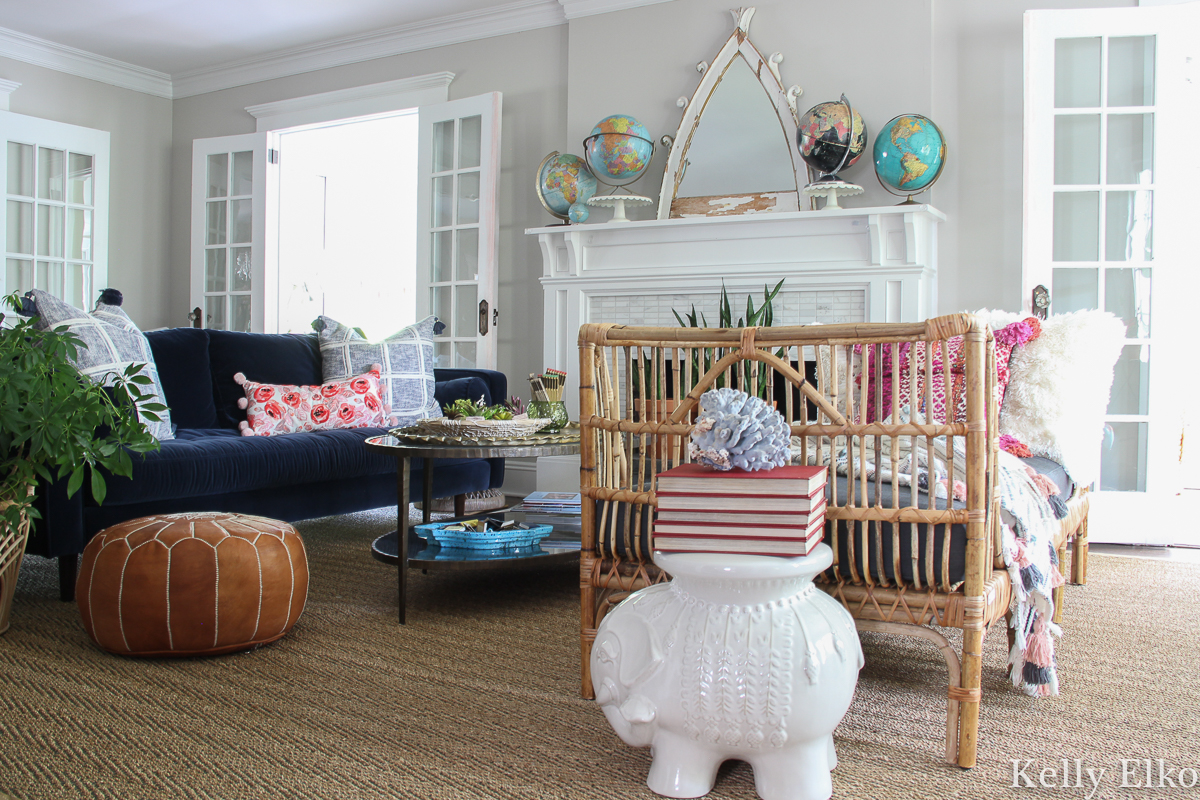 Love this eclectic boho living room with velvet sofa and rattan daybed and vintage globe collection kellyelko.com #livingroom #livingroomdecor #livingroomfurniture #manteldecor #eclecticdecor #bohodecor #rattan #rattanfurniture #daybed #furniturearranging #furniturearrangement #vintagedecor #modernvintage #interiordecor #ineriodesign #decorate #mantel #kellyelko #article #svensofa #collections #vintagecollection 