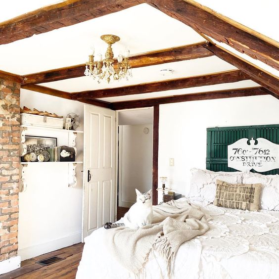 Cozy attic bedroom with wood beams and exposed brick wall #farmhouse #farmhousedecor #farmhousebedroom #neutraldecor #neutralbedroom #woodbeams #cottagebedroom #bedroom #bedroomdecor #vintagedecor #vintagehome 