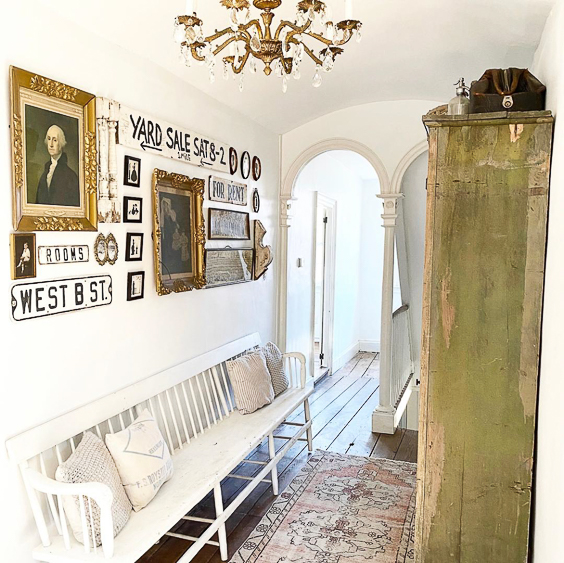 Tour this charming old home with an entry filled with antique finds like this chippy green cabinet and white bench #foyer #entry #farmhousedecor #farmhousefoyer #vintagedecor #vintage #antiques #gallerywall #fixerupperstyle 