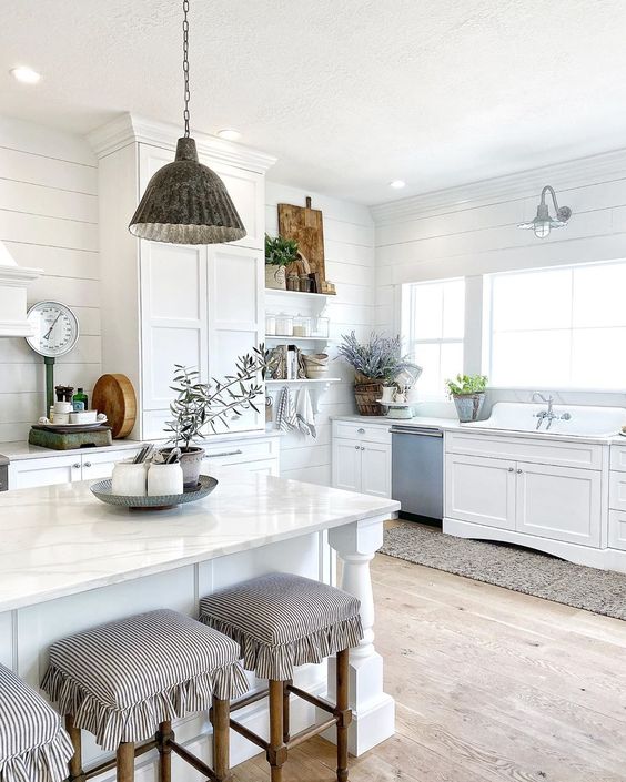 Beautiful white farmhouse kitchen with galvanized lighting and beautiful farmhouse sink kellyelko.com #farmhouse #farmhousedecor #farmhousesink #whitekitchen #shiplap #farmhouselighting #lighitng #fixerupper #neutraldecor