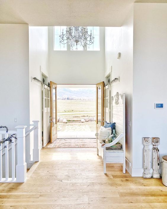 Tour this stunning farmhouse with beautiful foyer with crystal chandelier and rolling barn doors kellyelko.com #foyer #farmhouse #farmhousedecor #entry #vintagedecor #chandelier #rusticdecor #milkpaint 
