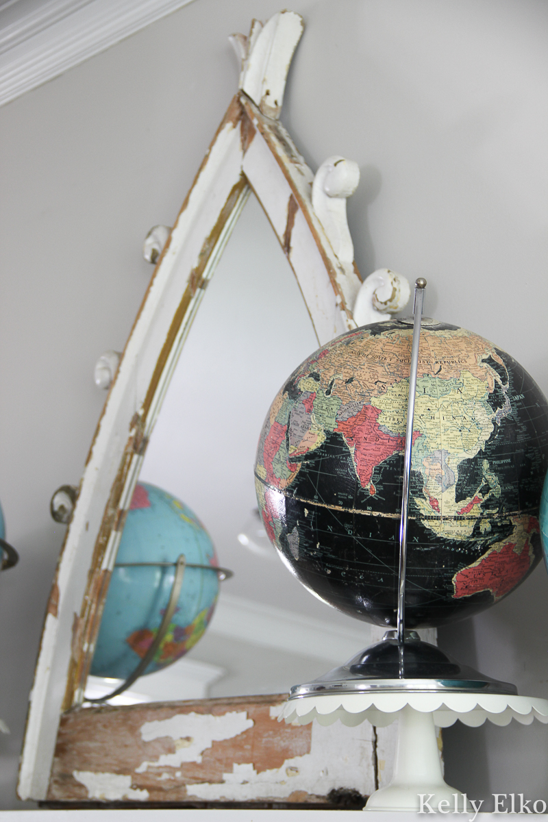 Vintage globe collection displayed on a mantel - love the unique black oceans globe kellyelko.com #globe #globes #vintageglobe #vintagedecor #vintagecollection #collection #collect #manteldecor #mantel #eclecticdecor #blackglobe #kellyelko 