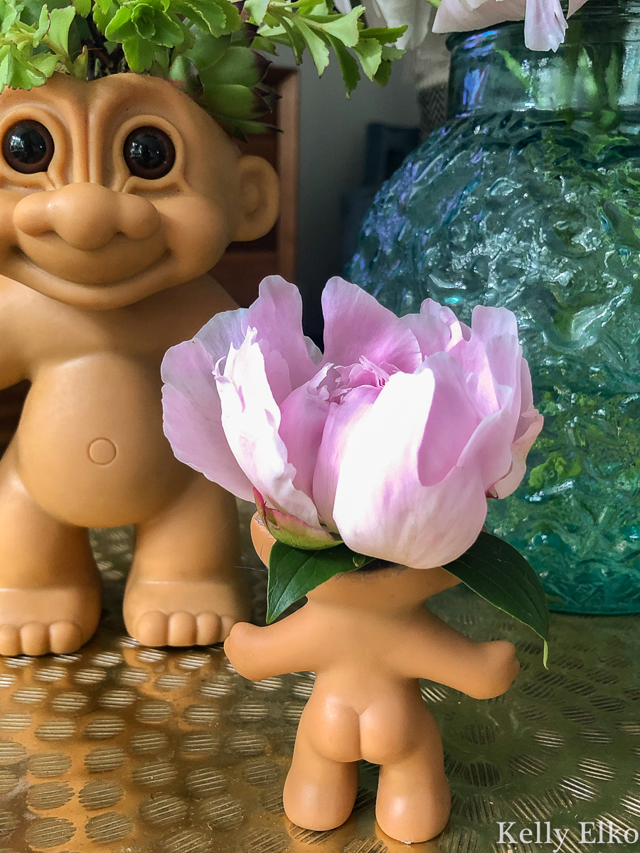 Turn a Troll doll into a kitschy planter or vase! kellyelko.com #troll #trolls #trolldolls #vintagedecor #upcycle #repurpose #kitsch #peonies #succulents #gardeners #houseplants #diyplanters #kidscrafts 