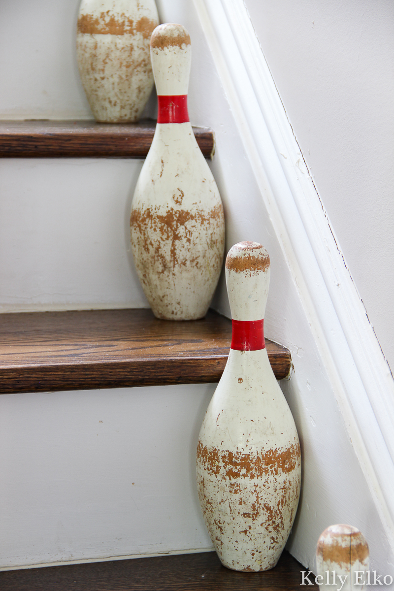 Vintage bowling pins on the staircase kellyelko.com #vintage #vintagedecor #farmhousedecor #farmhousestyle #farmhouse #stairs #staircase #thrifted 