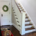 Vintage lawn bowling set on the stairs of this farmhouse foyer kellyelko.com #vintage #vintagedecor #farmhouse #farmhousedecor #farmhousefoyer #farmhouseentry #eclecticdecor #modernvintagedecor #modernvintage #cottagestyle #entry #foyer #thrifted #bowlingpins