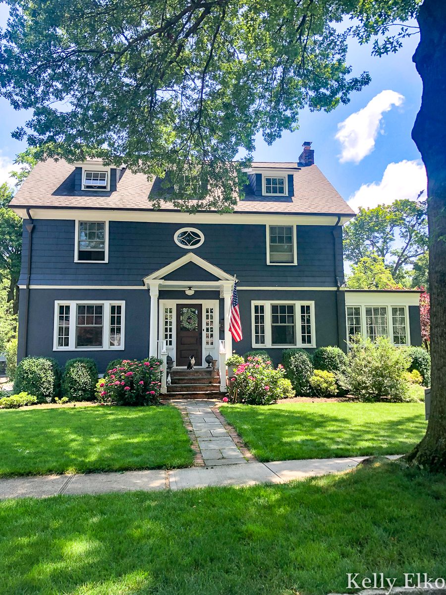 Love this bold Hale navy house kellyelko.com #blue #bluepaint #bluehouse #halenavy #housepaint #housecolors #curbappeal #oldhouse #oldhome #oldhouses #fixerupper #frontporch #landscaping #gardening #gardens #dormers #farmhouse #farmhousedecor 