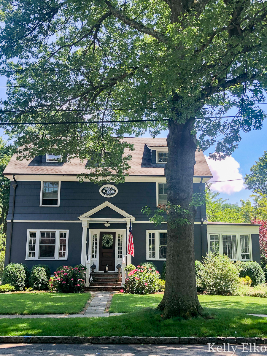 Love this bold Hale navy house kellyelko.com #blue #bluepaint #bluehouse #halenavy #housepaint #housecolors #curbappeal #oldhouse #oldhome #oldhouses #fixerupper #frontporch #landscaping #gardening #gardens #dormers #farmhouse #farmhousedecor 