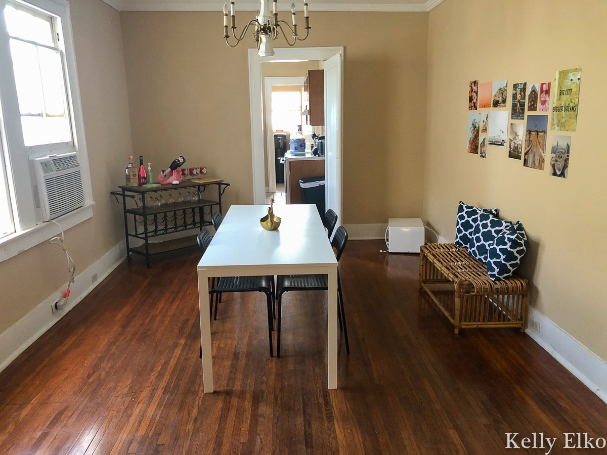 She furnished this college apartment on a budget in a mix of old and new finds for a very eclectic look kellyelko.com #diningroom #collegedecor #collegefurniture #vintagemodern #barcart #diningroomdecor #gallerywall