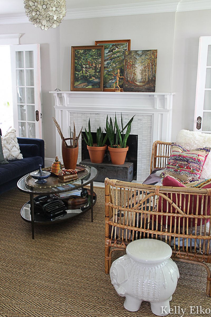 Beautiful fall home tour with so many creative, vintage details like the landscape paintings on the mantel #fall #falldecor #fallmantel #fallhometour #eclecticdecor #bohodecor #vintagedecor #houseplants #fireplacedecor #rattan 