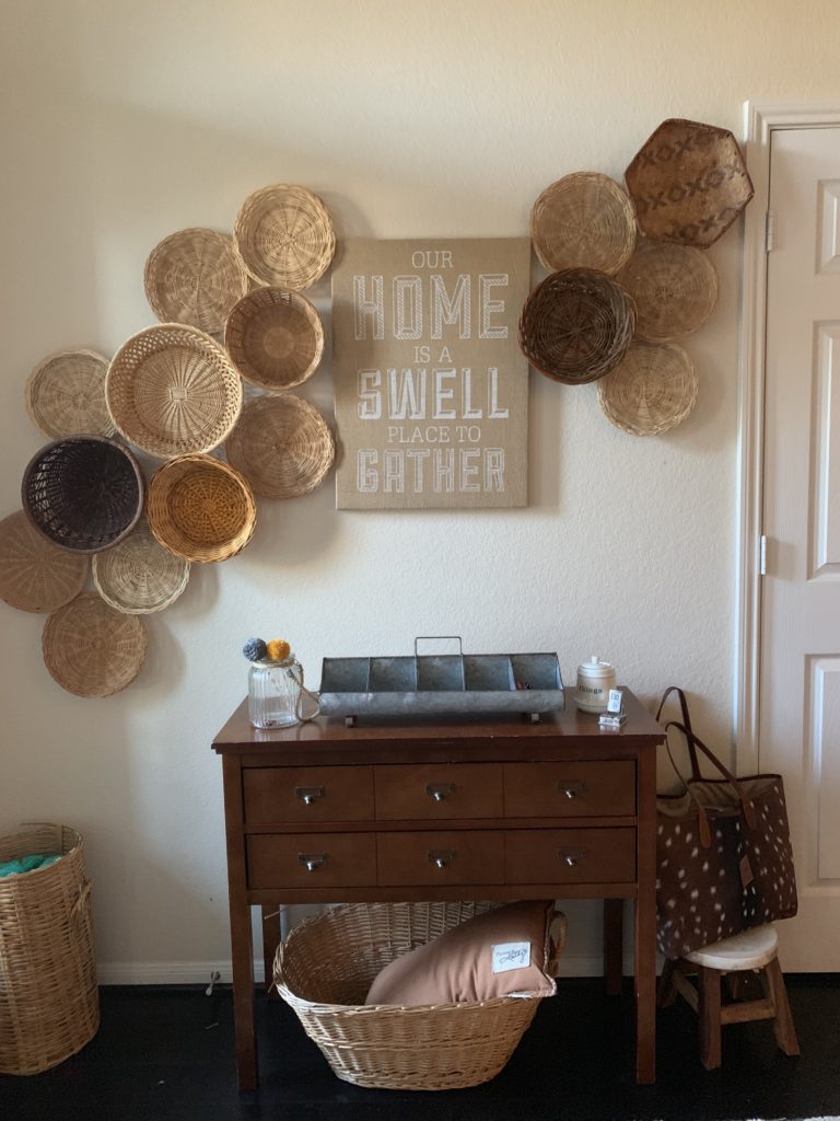 Gallery wall hanging tips - love the way she framed a piece of art with inexpensive baskets hung on the wall #baskets #bohodecor #art #diyart #eclecticdecor #gallerywall