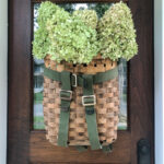 Adirondack Backpack History - love this gorgeous basket wreath filled with hydrangeas kellyelko.com #wreath #diywreath #adirondackbasket #basket #hydrangeas #falldecor
