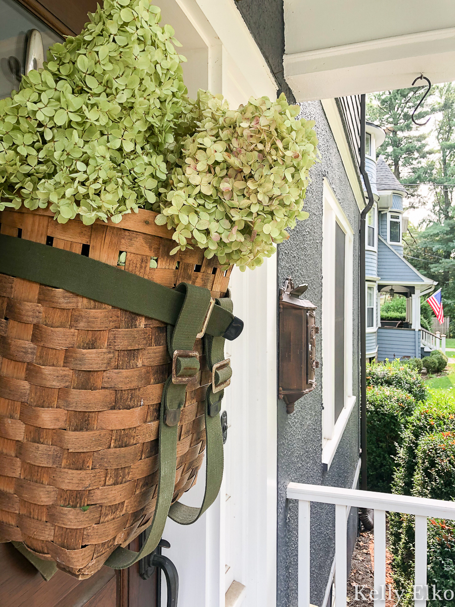 Love this basket wreath filled with hydrangeas kellyelko.com #basket #basketwreath #wreath #wreaths #fallwreath #summerwreath #curbappeal #diywreath #hydrangeas #limelight #vintagedecor #eclecticdecor #frontdoor