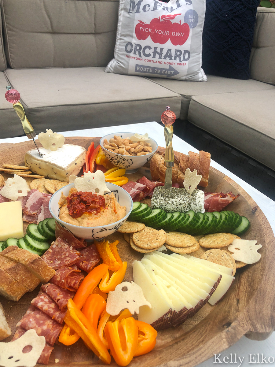 This fall charcuterie board is epic! I love the little ghost shaped crackers kellyelko.com #charcuterie #charcuterieboard #cheeseplatter #cheeseboard #meatandcheese #appetizers #partyfood #boards #fallfood #fallparty #fallcharcuterie #partyfood 