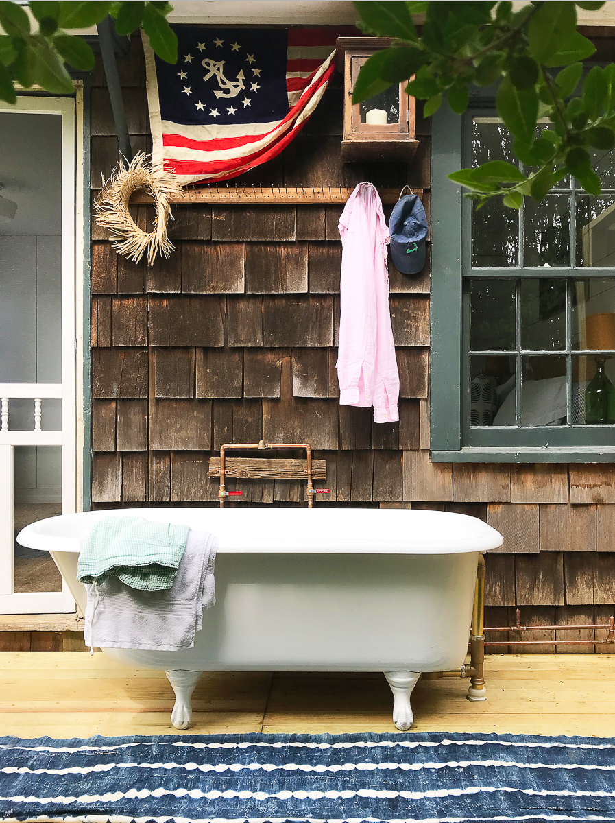 Tour this charming beach cottage with outdoor clawfoot bathtub kellyelko.com