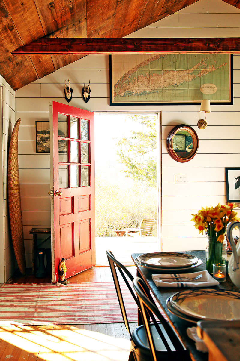 This charming cottage has a bright red door to welcome visitors kellyelko.com