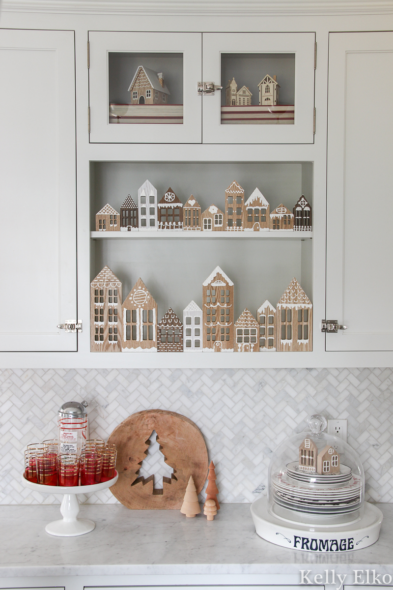 DIY Wood Gingerbread Houses - love the way she displays them in her kitchen cabinets kellyelko.com