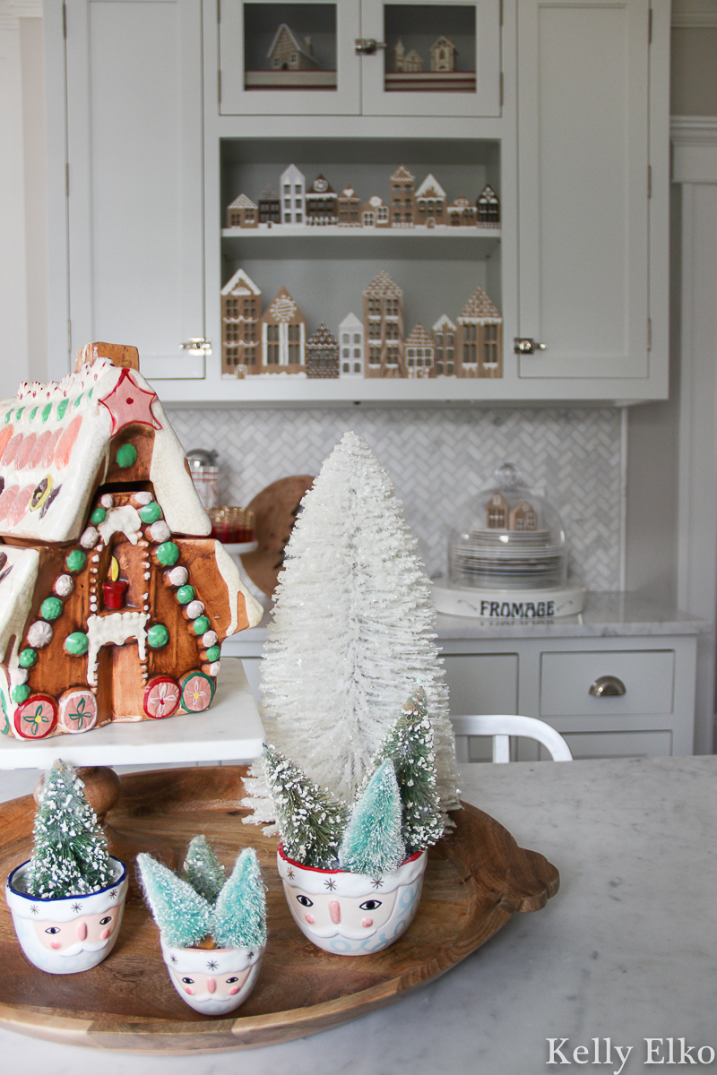 Beautiful Christmas kitchen with vintage gingerbread house cookie jar and a Diy wood cookie jar village kellyelko.com #vintagechristmas #christmaskitchen #retrochristmas #gingerbreadhouse #santa #santadecor #farmhousechristmas #diychristmas #bottlebrushtrees #christmashometour 