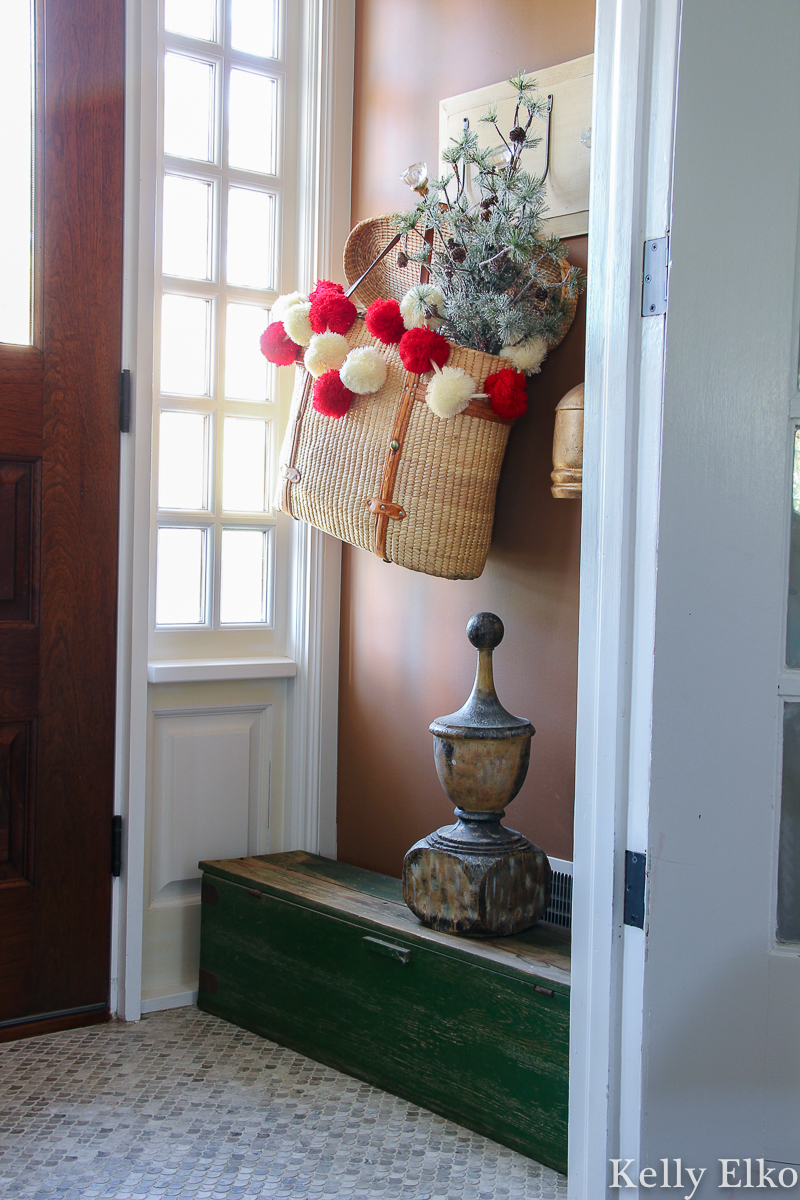 Colorful pom pom garland adds a pop of color to this Christmas tree kellyelko.com #christmas #christmashometour #christmasdecor #christmasgarland #vintagechristmas #pompomgarland #farmhousechristmas 