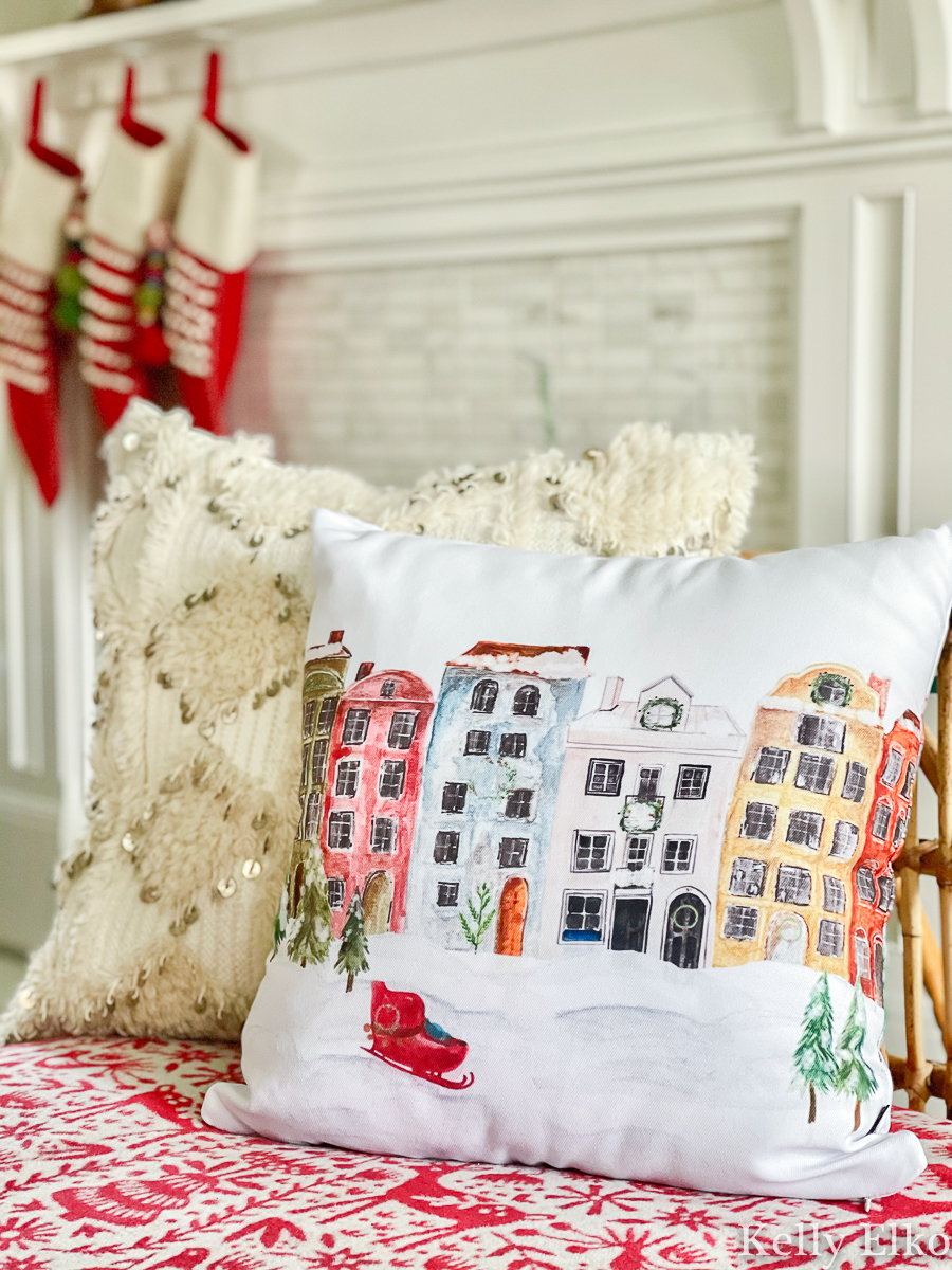 Love this colorful row of houses Christmas pillow kellyelko.com #pillow #christmaspillow #winterpillow #farmhousechristmas #colorfulchristmas #retrochristmas #vintagechristmas #christmashometour 