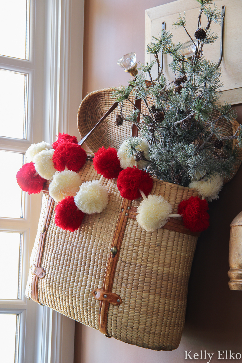 Colorful pom pom garland adds a pop of color to this Christmas tree kellyelko.com #christmas #christmashometour #christmasdecor #christmasgarland #vintagechristmas #pompomgarland #farmhousechristmas 